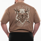 Man wearing a brown t-shirt with a graphic design on the back, standing against a white background