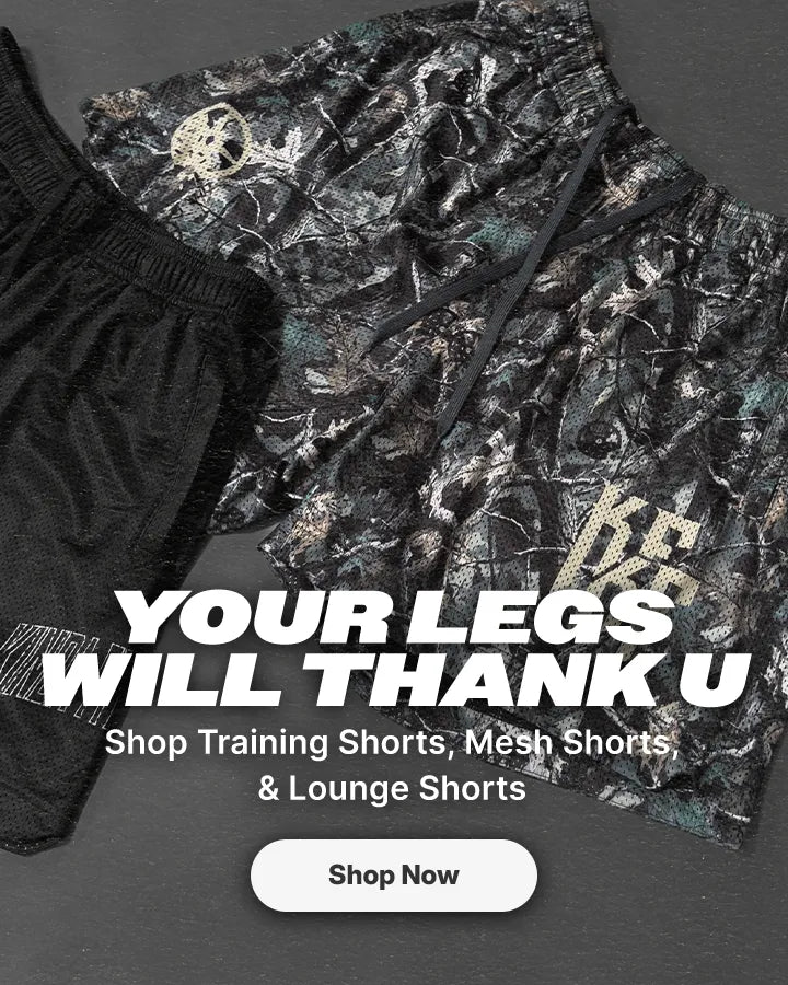 A promotional flat-lay showing two pairs of athletic shorts on a dark gray background: one pair in solid black and one pair in a camouflage pattern with black, gray, and muted green tones. Large overlaid text reads 'YOUR LEGS WILL THANK U' with smaller text 'Shop Training Shorts, Mesh Shorts & Lounge Shorts' and a white 'Shop Now' button.