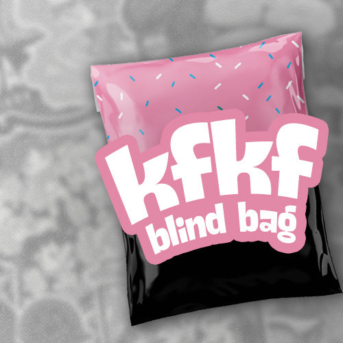 A pink and black mystery blind bag with a large 'kfkf blind bag' logo on the front, decorated with sprinkle details on the pink section, set against a gray background.