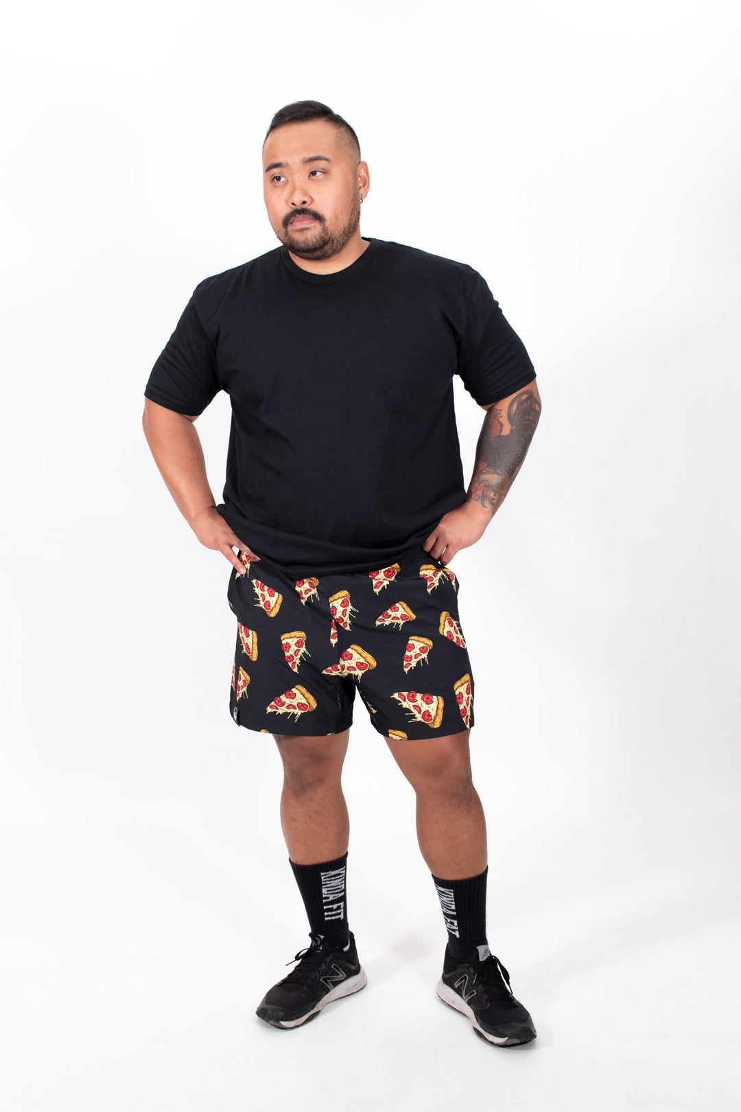 Dean wearing black Plateroni Pizza Training Shorts in size L