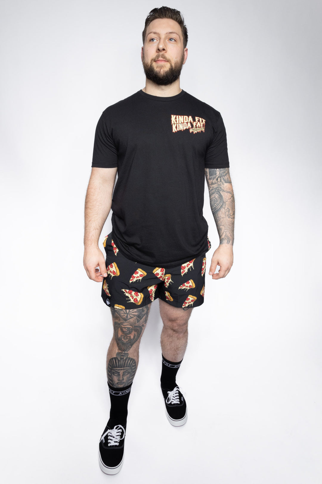Zack wearing black Plateroni Pizza Training Shorts in size large