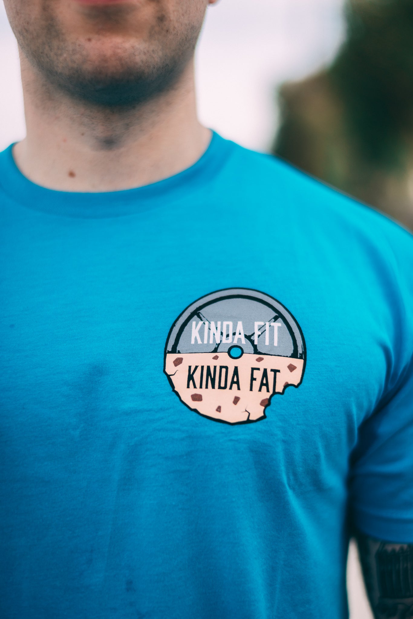 Kinda Fit Kinda Fat Premium Unisex Turquoise T-shirt. Original KFKF Cookie Logo on front left chest. Kinda Fit Kinda Fat Bar Logo Back. 