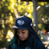 Model wearing Kinda Fit Kinda Fat Diamond Drip Logo Unisex Black Snapback Hat. Front shot.